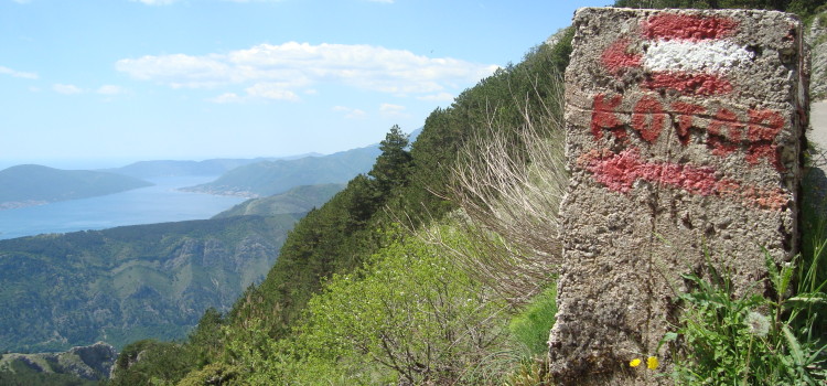 Beyond the Fortress Half way! The sign pointing back over the bay towards Kotor.